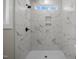 Clean and modern shower with marble-style tile at 531 Booth St, Roxboro, NC 27573