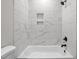 Bathroom with a shower/tub combo and marble tile at 531 Booth St, Roxboro, NC 27573