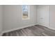 Bright bedroom with grey flooring and a window at 531 Booth St, Roxboro, NC 27573
