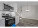 Modern kitchen with stainless steel appliances and white cabinets at 531 Booth St, Roxboro, NC 27573