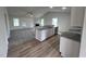 Open kitchen with island, granite counters, and white cabinets at 32 Scotties Ridge Dr, Princeton, NC 27569