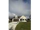 Beige house with brown accents, double garage, and green lawn at 32 Scotties Ridge Dr, Princeton, NC 27569