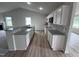Open kitchen with island, granite counters, and white cabinets at 32 Scotties Ridge Dr, Princeton, NC 27569