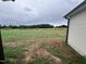 Open grassy backyard with partial house view at 32 Scotties Ridge Dr, Princeton, NC 27569