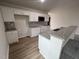 Open kitchen with island, granite counters, and white cabinets at 32 Scotties Ridge Dr, Princeton, NC 27569