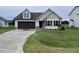 Beige house with brown accents, double garage, and green lawn at 32 Scotties Ridge Dr, Princeton, NC 27569