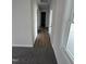 Clean hallway with wood-look flooring leading to bedrooms and bath at 32 Scotties Ridge Dr, Princeton, NC 27569