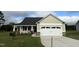 Tan house with a two-car garage and landscaping at 158 Scotties Ridge Dr, Princeton, NC 27569