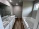 Main bathroom with double vanity and garden tub at 158 Scotties Ridge Dr, Princeton, NC 27569