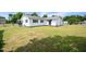White house exterior with black windows and a large grassy backyard at 101 Mulberry Ln, Dunn, NC 28334