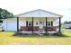 Ranch house with covered porch and rocking chairs at 101 Mulberry Ln, Dunn, NC 28334