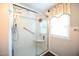 Updated walk-in shower with glass enclosure and shelving at 101 Mulberry Ln, Dunn, NC 28334