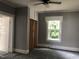Bright bedroom with wood closet doors and ceiling fan at 3124 Raleigh Rd, Henderson, NC 27537