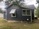 Gray house exterior with a green awning and brick base at 3124 Raleigh Rd, Henderson, NC 27537