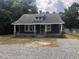 Charming one-story home with a spacious front porch and gravel driveway at 3124 Raleigh Rd, Henderson, NC 27537