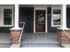 Gray house with red front door and a porch at 3124 Raleigh Rd, Henderson, NC 27537