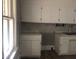 Kitchen with white cabinets and hexagon backsplash at 3124 Raleigh Rd, Henderson, NC 27537