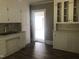Kitchen featuring white cabinets and wood flooring at 3124 Raleigh Rd, Henderson, NC 27537