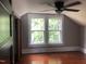 Charming bedroom with hardwood floors and two windows at 3124 Raleigh Rd, Henderson, NC 27537