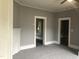 Living room with gray walls and multiple doorways at 3124 Raleigh Rd, Henderson, NC 27537