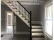 Elegant staircase with dark wood and white railings at 3124 Raleigh Rd, Henderson, NC 27537