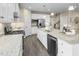 Open kitchen with white cabinets, granite countertops, and stainless steel appliances at 508 Impala Trce, Wendell, NC 27591