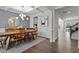 Elegant dining room with hardwood floors, chandelier, and a large table at 541 Henham Way, Zebulon, NC 27597