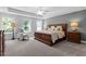 Large Primary bedroom with king-size bed, two night stands and seating area at 541 Henham Way, Zebulon, NC 27597