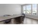 Home office with hardwood floors, large windows and a modern desk at 541 Henham Way, Zebulon, NC 27597