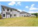 Two-story house with gray siding, a backyard, and a fence at 541 Henham Way, Zebulon, NC 27597