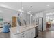 Modern kitchen with island, white cabinets, and stainless steel appliances at 541 Henham Way, Zebulon, NC 27597