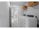 Convenient laundry room with washer, dryer, and shelving at 541 Henham Way, Zebulon, NC 27597
