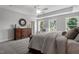 Spacious Primary bedroom with king-size bed, dresser, and window seating at 541 Henham Way, Zebulon, NC 27597