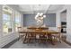 Bright dining room featuring a spacious table, chandelier, and view of the backyard at 541 Henham Way, Zebulon, NC 27597