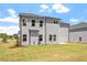 Two-story house with gray siding, a backyard, and landscaping at 541 Henham Way, Zebulon, NC 27597