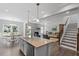 Open concept kitchen with large island and stainless steel appliances at 541 Henham Way, Zebulon, NC 27597