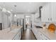 Modern kitchen with white cabinets, a large island, and stainless steel appliances at 541 Henham Way, Zebulon, NC 27597