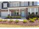 Front porch with stone columns and landscaping at 541 Henham Way, Zebulon, NC 27597