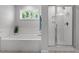 Spa-like bathroom featuring a soaking tub and a shower at 541 Henham Way, Zebulon, NC 27597