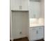 White laundry room cabinets and quartz countertop at 200 Whistlers Cv, Louisburg, NC 27549