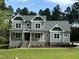 Two-story home with gray siding and stone accents at 200 Whistlers Cv, Louisburg, NC 27549
