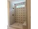 Spa-like shower with patterned tile and built-in seat at 200 Whistlers Cv, Louisburg, NC 27549