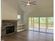 Gathering room with stone fireplace, built-in shelving, and sliding doors to patio at 200 Whistlers Cv, Louisburg, NC 27549