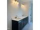 Double vanity with dark cabinets and quartz countertop at 200 Whistlers Cv, Louisburg, NC 27549