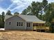 Gray house with wooden deck and backyard at 200 Whistlers Cv, Louisburg, NC 27549