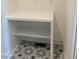 Laundry room with white built-in shelving and patterned tile floor at 200 Whistlers Cv, Louisburg, NC 27549
