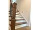 View of a staircase with a dark wood handrail and white risers at 200 Whistlers Cv, Louisburg, NC 27549