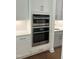 Stacked wall oven, microwave, and warming drawer in a white kitchen at 200 Whistlers Cv, Louisburg, NC 27549