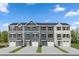 Four townhouses with gray and beige siding, two-car garages, and landscaping at 4507 Black Drum Dr, Raleigh, NC 27616