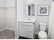 Simple bathroom with toilet, vanity, and access to a walk-in closet at 4511 Black Drum Dr, Raleigh, NC 27616